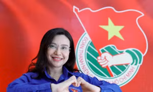 Chị Nguyễn Phạm Duy Trang, bí thư Trung ương Đoàn, chủ tịch Hội đồng Đội Trung ương chụp hình với lá cờ của Đoàn