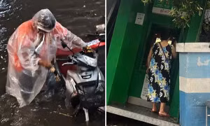 Cây ATM đổ nghiêng sau cơn dông, người phụ nữ vẫn vào thực hiện giao dịch