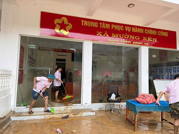 Cán bộ Phòng giao dịch NHCSXH Kỳ Sơn đồng hành cùng nhân dân xã Mường Xén khắc phục hậu quả lũ lụt