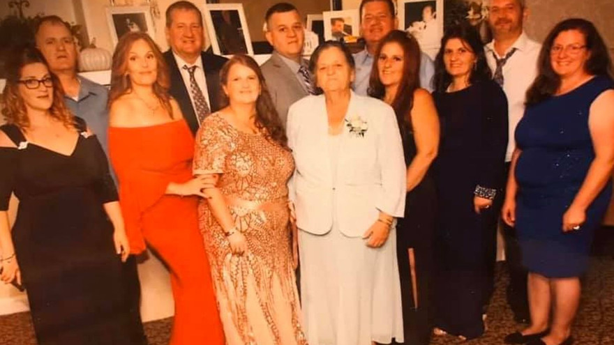 Bà Grace mặc áo váy trắng đứng giữa