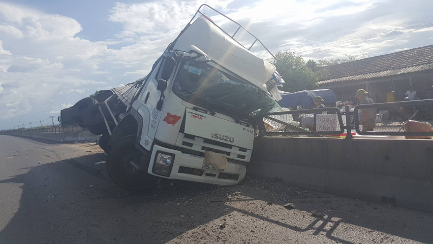 Phần đầu xe tải găm chặt vào giải phân cách giữa quốc lộ.