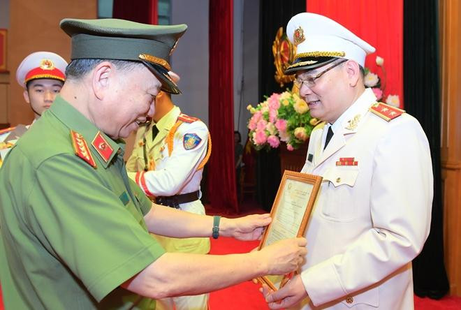 Thừa ủy quyền của Chủ tịch nước, Bộ trưởng Tô Lâm trao quyết định cho Trung tướng Tô Ân Xô.. Ảnh CAND