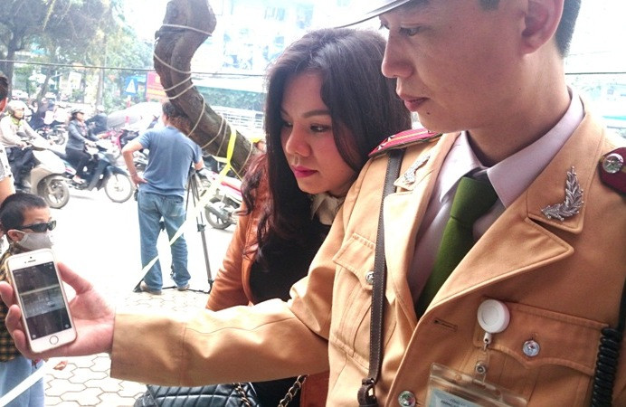 CSGT mở hình ảnh vi phạm cho chủ phương tiện xem. Ảnh: Hiệp Gia