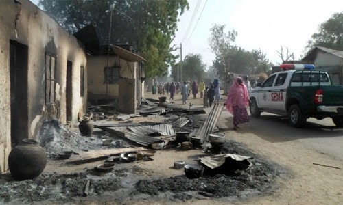 Người dân đi qua khu vực thảm sát hôm 30/1. Ảnh: AFP