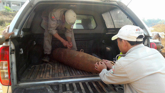 Lực lượng chức năng đang đưa quả bom đến nơi an toàn để tiến hành hủy nổ. ẢNH: Đ.QUỐC.