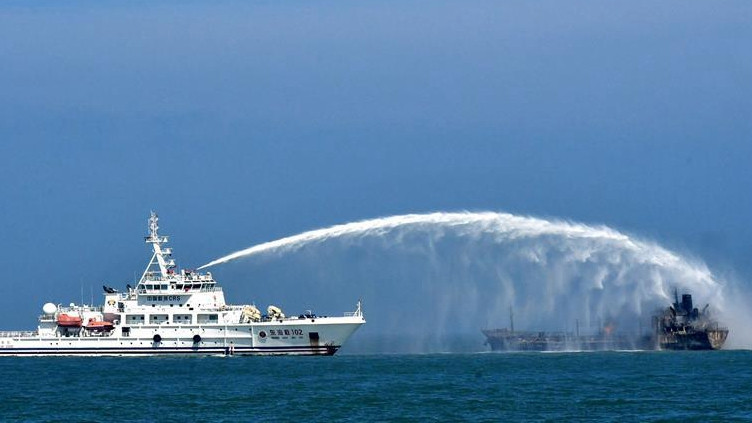 Tàu cứu hộ chữa cháy cho tàu chở dầu. Ảnh: Tân Hoa Xã