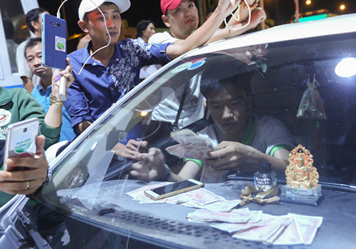 Tài xế chuẩn bị nhiều tiền lẻ mệnh giá 200, 500... đồng để mua vé qua trạm thu phí. Ảnh: Quỳnh Trần