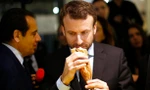 Tổng thống Pháp hít hà một chiếc bánh mì baguette. Ảnh: AFP