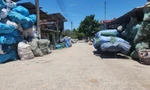 Vật liệu tái chế được người dân thu gom, phân loại xếp hai bên đường vào làng