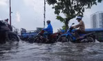 Người dân TPHCM bì bõm về nhà khi triều cường dâng cao