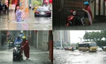Mưa lớn khiến người và xe ở Hà Nội 'bơi' trên phố