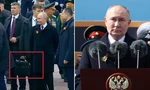 Tổng thống Nga Vladimir Putin phát biểu trên Quảng trường Đỏ dịp kỷ niệm Chiến thắng phát xít 9/5/2024 và trợ lý cầm vali đen được cho là cheget. Ảnh: Reuters.