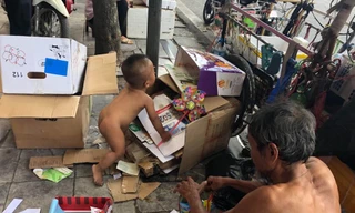 Ông Lê Thanh Toàn và cháu bé 18 tháng tuổi cùng kiếm sống trên đường phố.