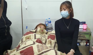 Một nạn nhân (trái) được người thân chăm sóc ở bệnh viện. Ảnh: Zing