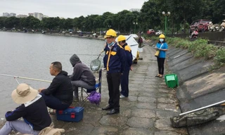 Câu cá trái phép trên hồ Định Công đang diễn ra công khai. Trong ảnh, nhân viên Cty Thoát nước ra nhắc nhở nhưng câu cá vẫn diễn ra.
