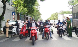 Tổ tuần tra kiểm soát kiểm tra giấy tờ người đi đường.