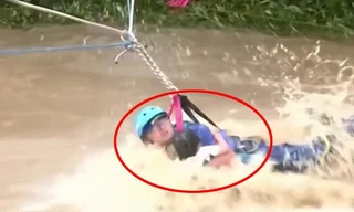 Nhân viên cứu hộ liều mạng giải cứu đứa trẻ giữa dòng nước lũ