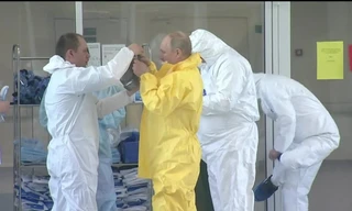 Tổng thống Putin mặc đồ bảo hộ khi đi thăm các bệnh nhân Covid-19. Ảnh: CNN