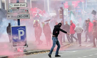 Một người biểu tình ném bom xăng vào cảnh sát sau khi cuộc biểu tình biến thành đụng độ. Ảnh: AFP 