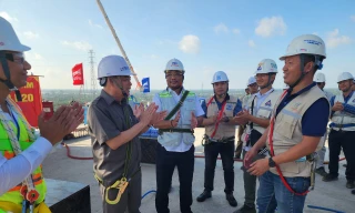 Chủ tịch UBND tỉnh Bến Tre Trần Ngọc Tam (áo sẫm màu) trò chuyện với cán bộ, kỹ sư tại sự kiện căng bó cáp đầu tiên của dự án cầu Rạch Miễu 2