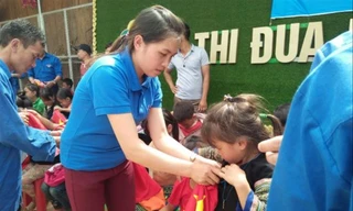 Bí thư Đoàn xã Lao Chải Lý Thị Thiêm tặng quà cho trẻ em dân tộc thiểu số Ảnh: CTV 