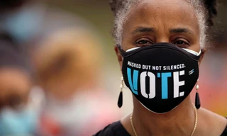 Một cử tri da màu Mỹ đeo khẩu trang có dòng chữ: “Che mặt nhưng không im lặng. Bầu cử” Ảnh: Getty 