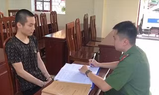 Đối tượng Hoàng Văn Tuấn (bìa trái) tại cơ quan công an -Ảnh: H.T