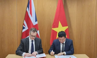 Ông Michael Tomlinson - Thứ trưởng phụ trách phòng chống xuất nhập cảnh trái phép, Bộ Nội vụ Anh, và Đại tá Vũ Văn Hưng - Phó Cục trưởng Cục Quản lý Xuất nhập cảnh, Bộ Công an Việt Nam, ký Tuyên bố chung tại London ngày 17/4. (Ảnh: ĐSQ Anh)