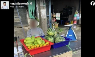 Người đàn ông treo biển rao bán mắt ở quầy trái cây. (Ảnh: ST)