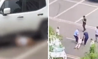 Chiếc xe trắng nhiều lần cán lên người nạn nhân ở bãi đỗ. (Ảnh từ clip)