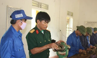 Thượng úy Đậu Bá Xuân (thứ 2, trái sang) đang hướng dẫn tổ sửa chữa ứng dụng sáng kiến mới