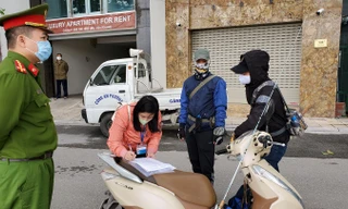 Lực lượng chức năng xử phạt người vi phạm quy định về hạn chế ra đường trong phòng chống dịch COVID-19. Ảnh: PV