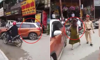 Bị CSGT nhắc nhở, nữ tài xế đỗ ô tô giữa đường chống đối