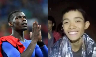 Paul Pogba (trái) và cầu thủ nhí Thái Lan (phải). 