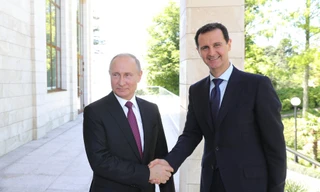 Tổng thống Nga Putin bắt tay Tổng thống Syria Assad. Ảnh: Sputnik