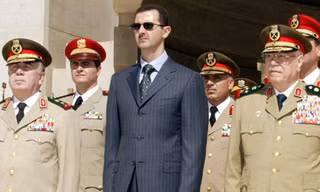 Tổng thống Syria Bashar al-Assad (áo đen). Ảnh: Sputnik