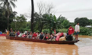 Người dân sơ tán sau sự cố vỡ đập. Ảnh: AFP