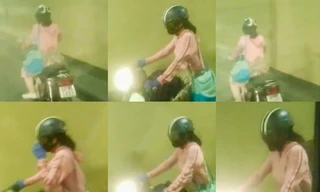 Cô gái trẻ điều khiển xe máy, vượt các chốt chặn để chạy xuyên hầm Hải Vân. Ảnh: chụp lại clip. 
