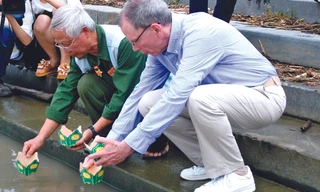 Hai cựu chiến binh Lê Bá Dương và Mike thả hoa đăng trên sông Thạch Hãn