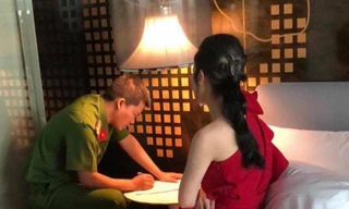 Công an làm việc với một cô gái bán dâm.