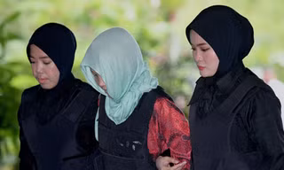 Đoàn Thị Hương mặc áo chống đạn, bị áp giải đến tòa án ở ngoại ô Kuala Lumpur sáng nay. Ảnh: AFP