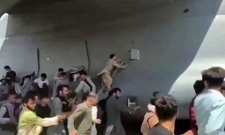 Người dân Afghanistan đu bám chiếc máy bay để mong thoát khỏi đất nước. (Ảnh: AP)