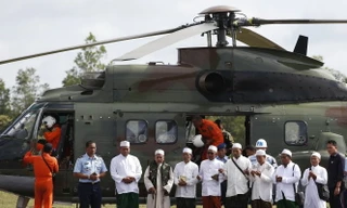 Các giáo sĩ Hồi giáo cầu nguyện trước khi lên trực thăng của quân đội Indonesia để tới hiện trường vụ máy bay rơi và cầu nguyện cho các nạn nhân - Ảnh: Reuters