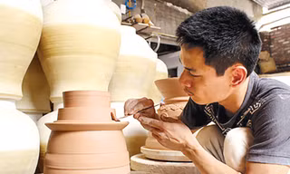 Anh Phạm Anh Đạo đang hoàn thiện sản phẩm gốm của mình. Ảnh: Q.L