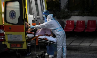 Nhân viên y tế đưa một bệnh nhân COVID-19 lên xe cấp cứu ở Hy Lạp. Ảnh: Reuters