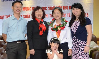 Nga Nhi cùng gia đình và cô giáo chủ nhiệm sau một lần nhận giải thưởng quốc tế.