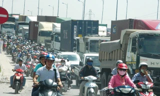 Xe tải và xe máy chen chúc qua cầu Rạch Chiếc (TPHCM). Cây cầu vừa được đầu tư xây mới với kinh phí gần 1.000 tỷ đồng nhưng đã quá tải.