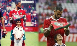 Xúc động bức ảnh cầu thủ Ma rốc che mưa cho bé gái trên sân cỏ