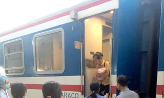 Mẹ con sản phụ được đưa xuống tàu để vào theo dõi tại bệnh viện ở ga Huế. Ảnh VNR.