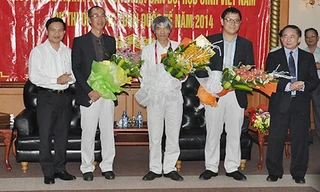 Thứ trưởng Bộ GD-ĐT Bùi Văn Ga (ngoài cùng bên phải) và Cục trưởng Cục Khảo thí & Kiểm định chất lượng, Bộ GD-ĐT Mai Văn Trinh (ngoài cùng bên trái) chúc mừng các thầy cô trong đoàn đưa thí sinh dự thi IM) 2014 trở về tại sân bay Nội Bài trưa 14/7.